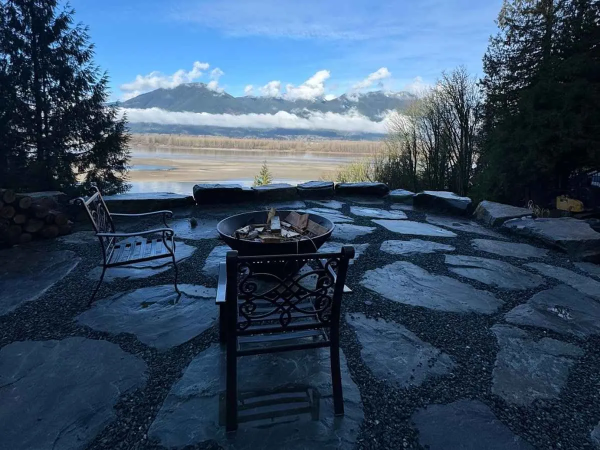 A flagstone patio with a fire pit looking out over the valley