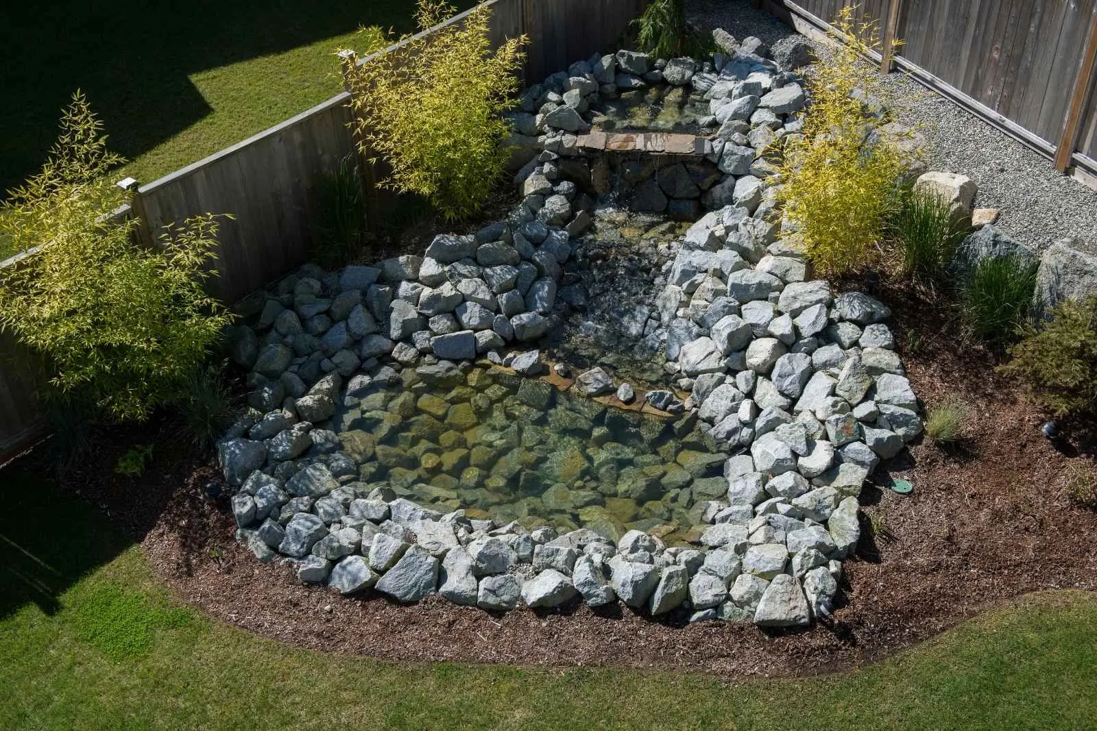 A river rock path running through planting