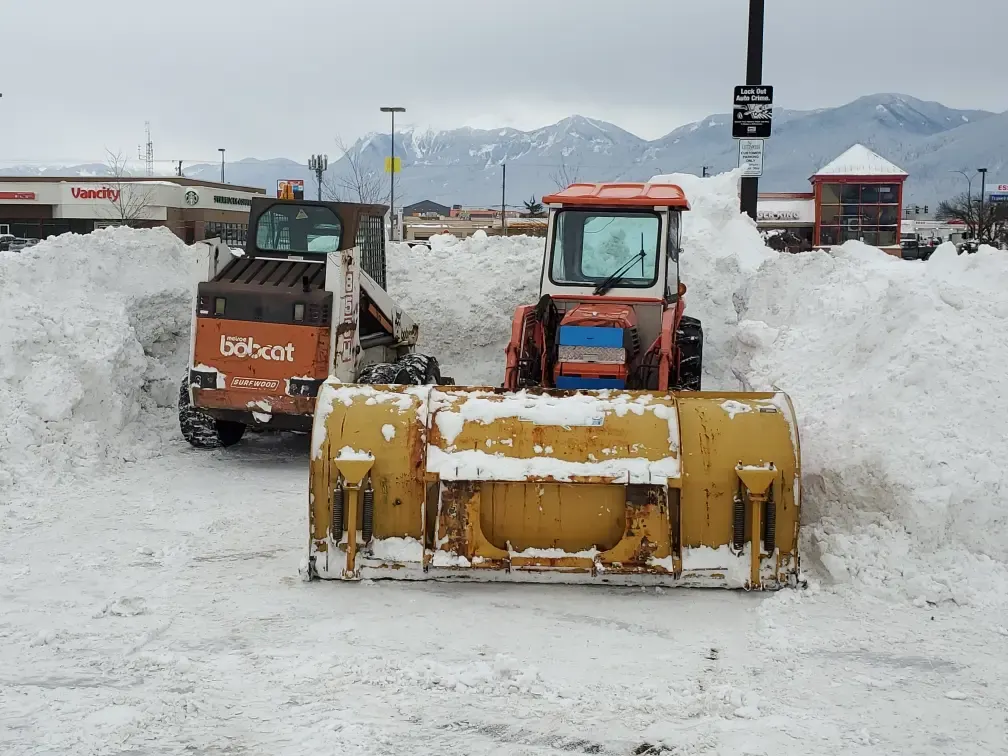 Snow piled at the edge of a commercial lot
