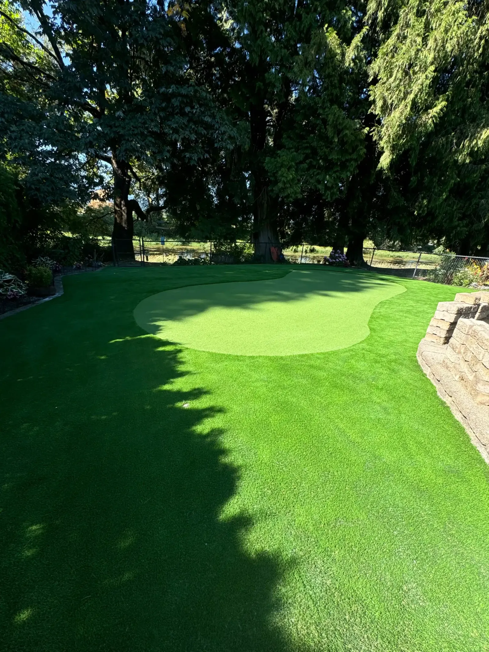 A contoured artificial putting green
