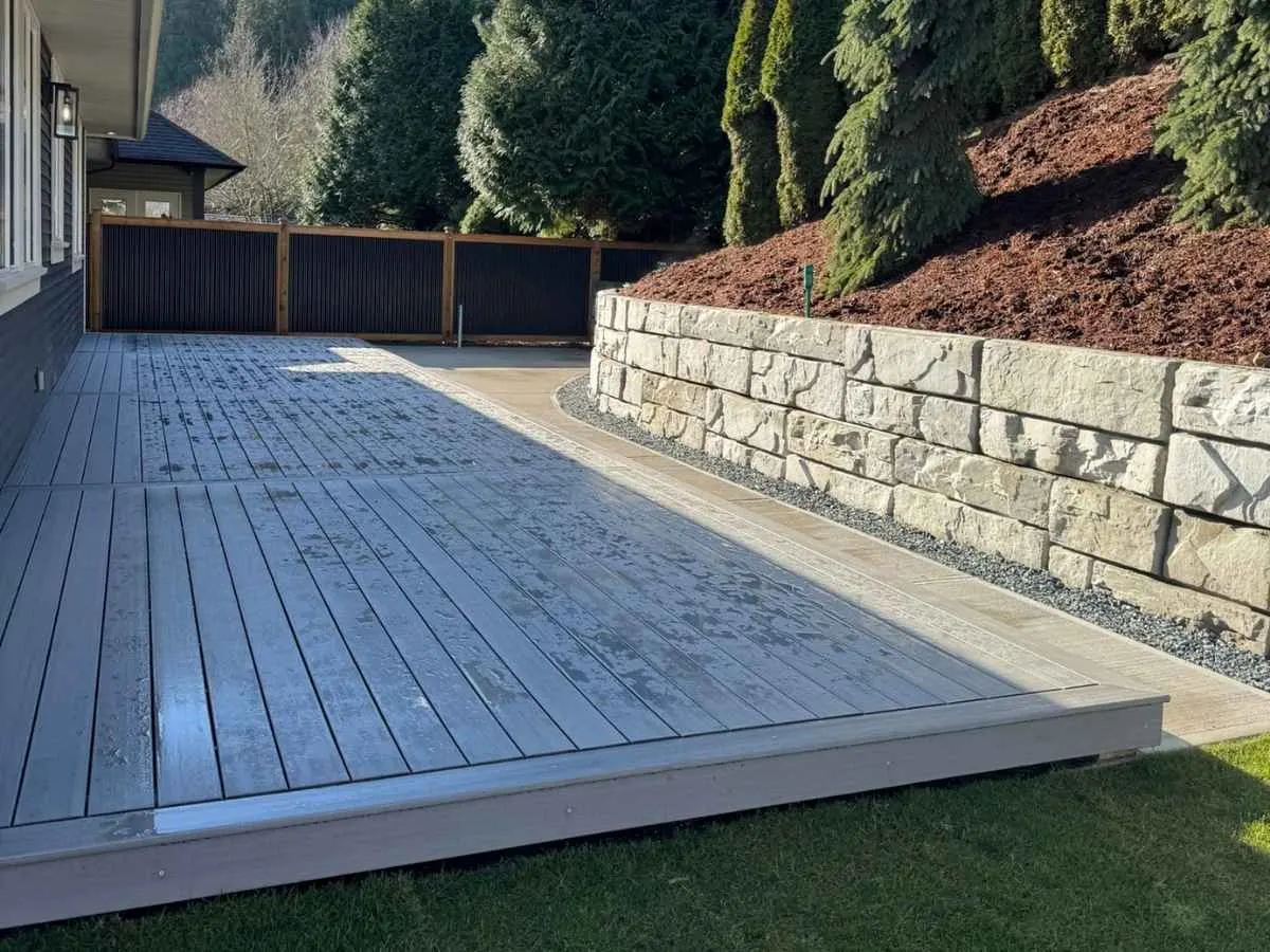 A block wall holding a level beside a finished deck
