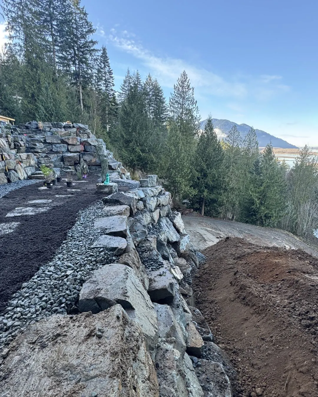 The finished rock wall on Chilliwack Mountain with the valley behind it