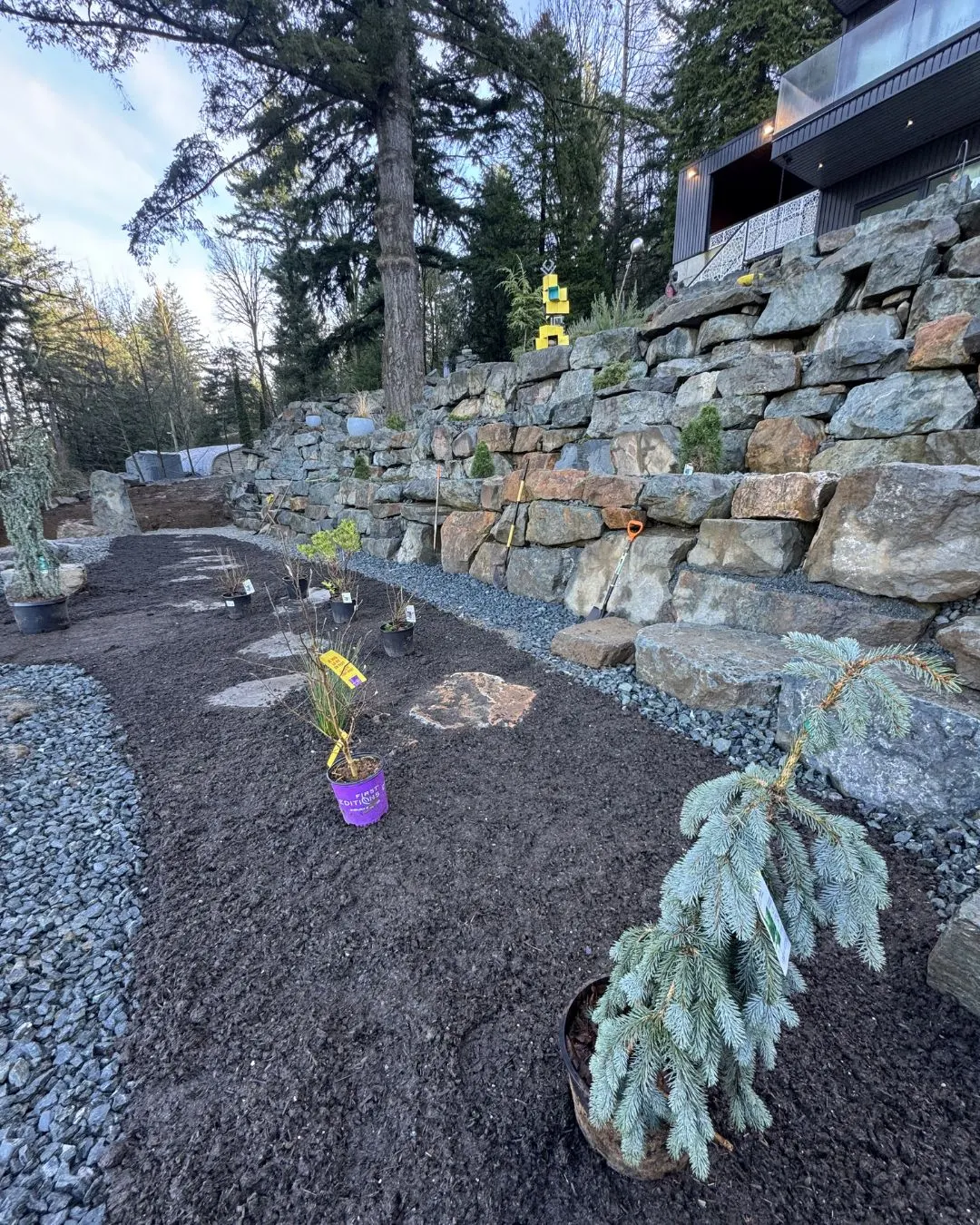 A rock wall with planting beds above it