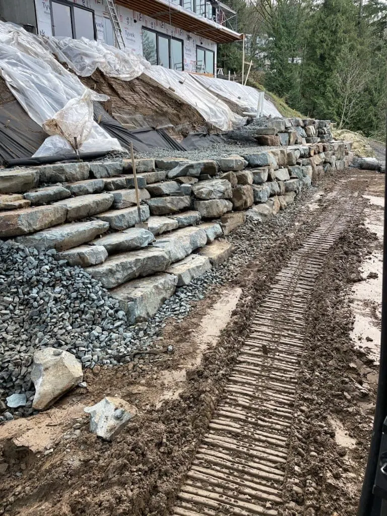 A terraced rock wall under construction